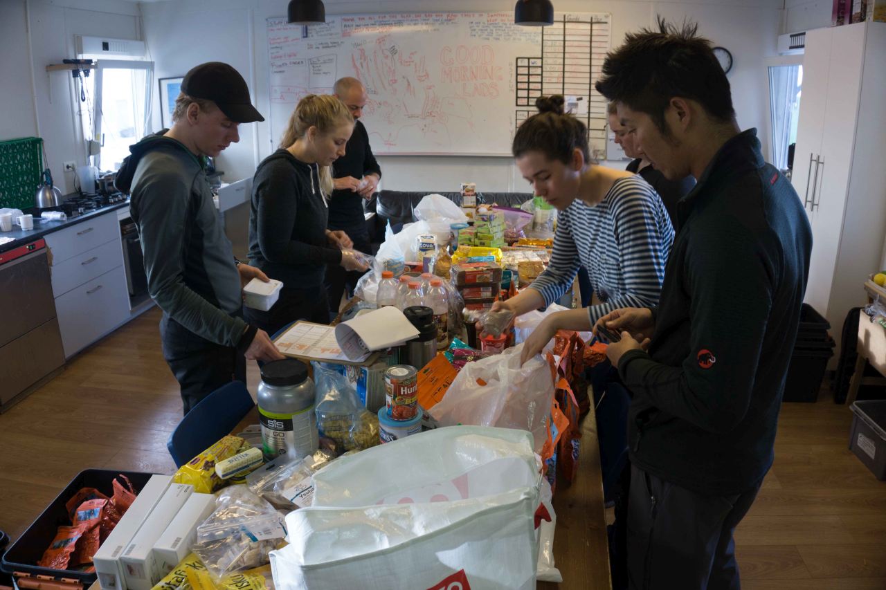 People preparing food on a polar training course with Icelandic Mountain Guides