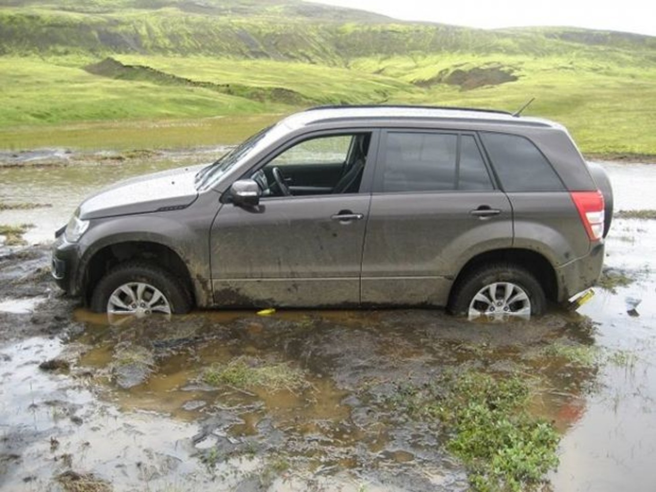 A car stuck in water after illegal off road driving