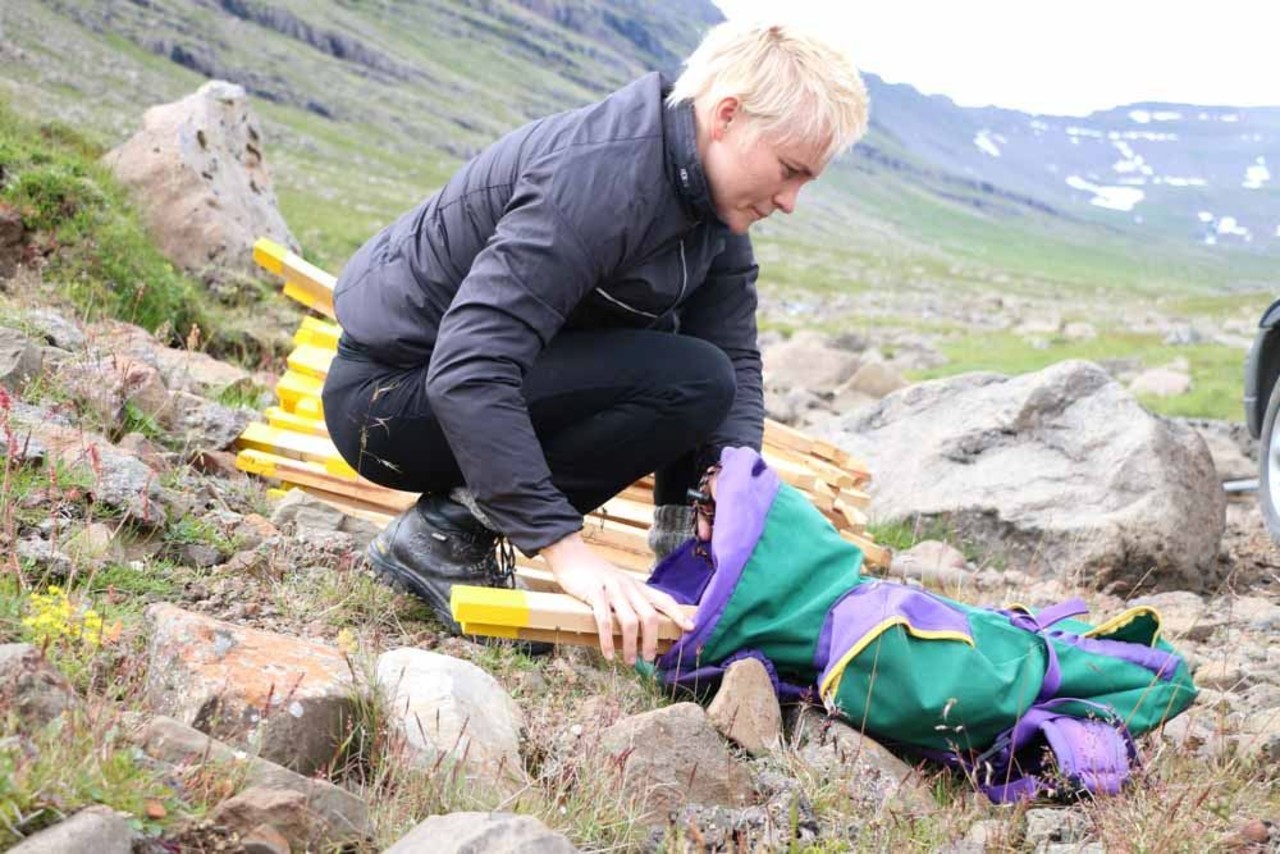 A girl getting the pegs ready for setting to mark a hiking trail for Icelandic Mountain Guides in Iceland