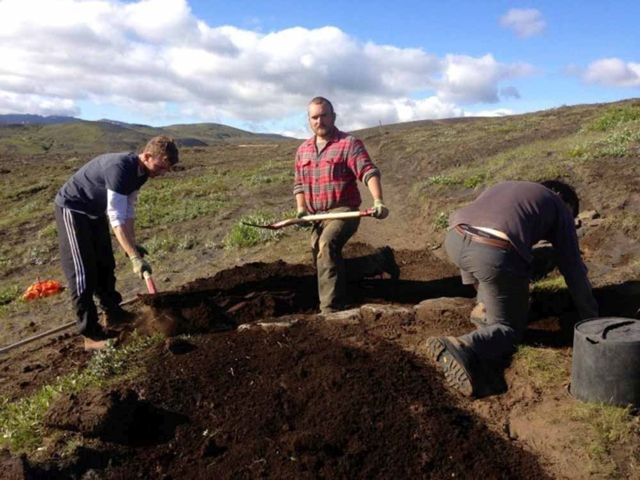 Three men working hard on digging in Iceland