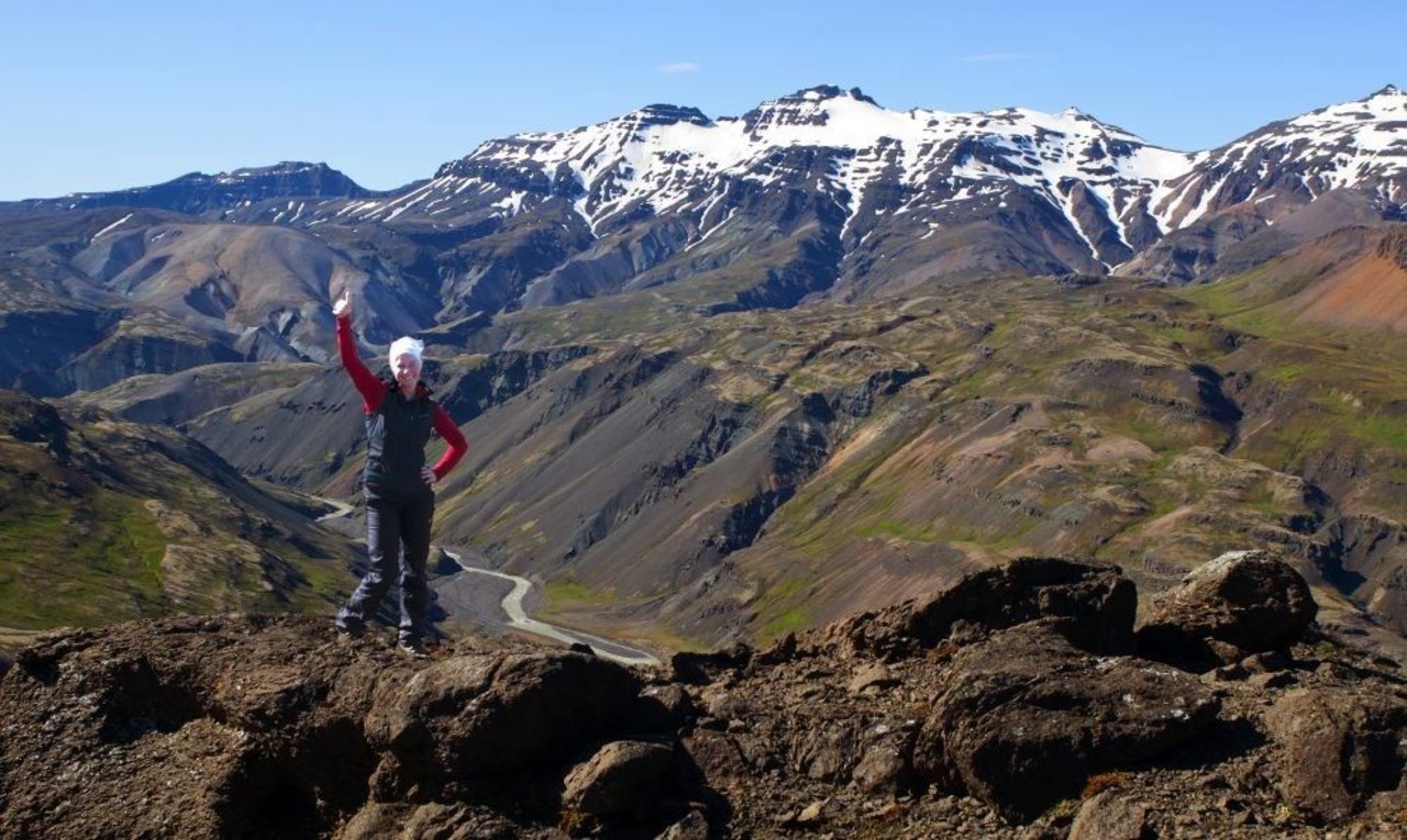 A woman standing on a cliff looking over Lónsöræfi on a tour with Icelandic Mountain Guides.