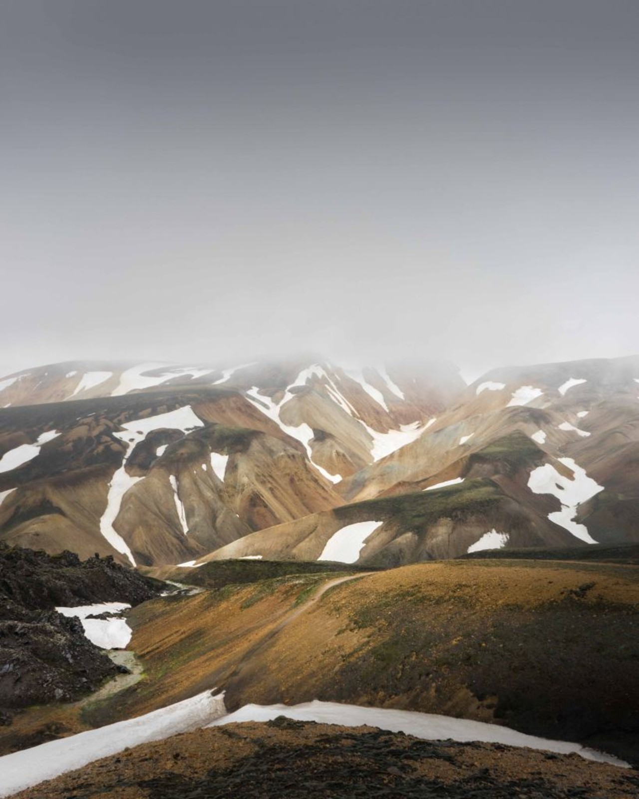 The colorful rhyolite mountains seen as you trek from Landmannalaugar to Thorsmork on the Laugavegur trail in the Icelandic highlands.